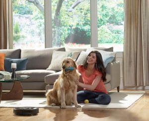 Woman and Dog Near The Automatic Vacuum Cleaner