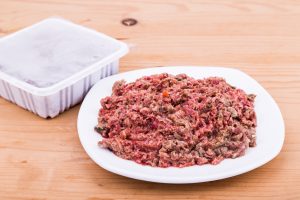Raw dog food packed and served on a plate