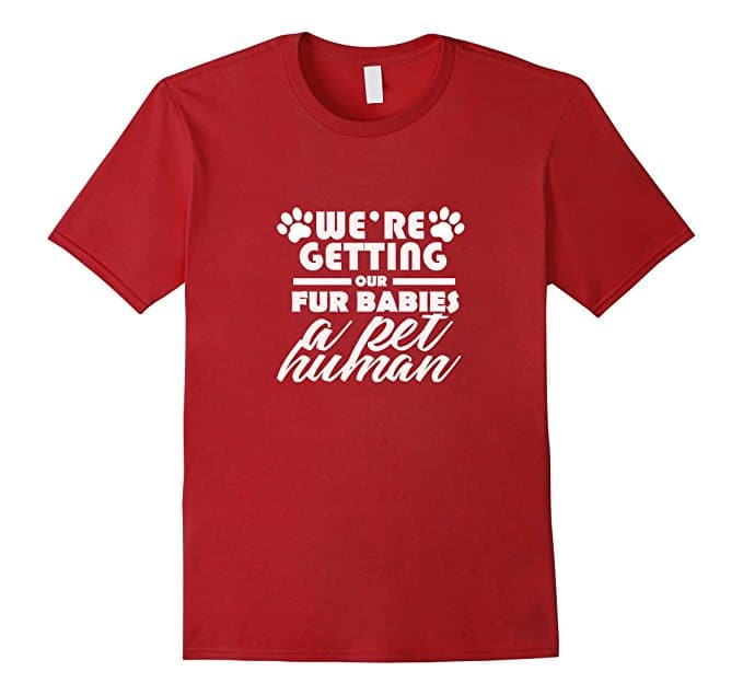Red T-shirt with paw prints and white writing We're getting our fur babies a pet human