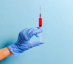 person holding syringe