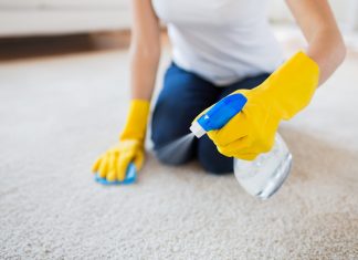 close up of woman with cloth cleaning carpet